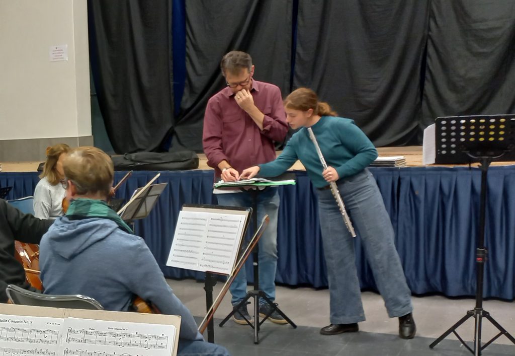 Conductor and Soloist Conferring during a rehearsal