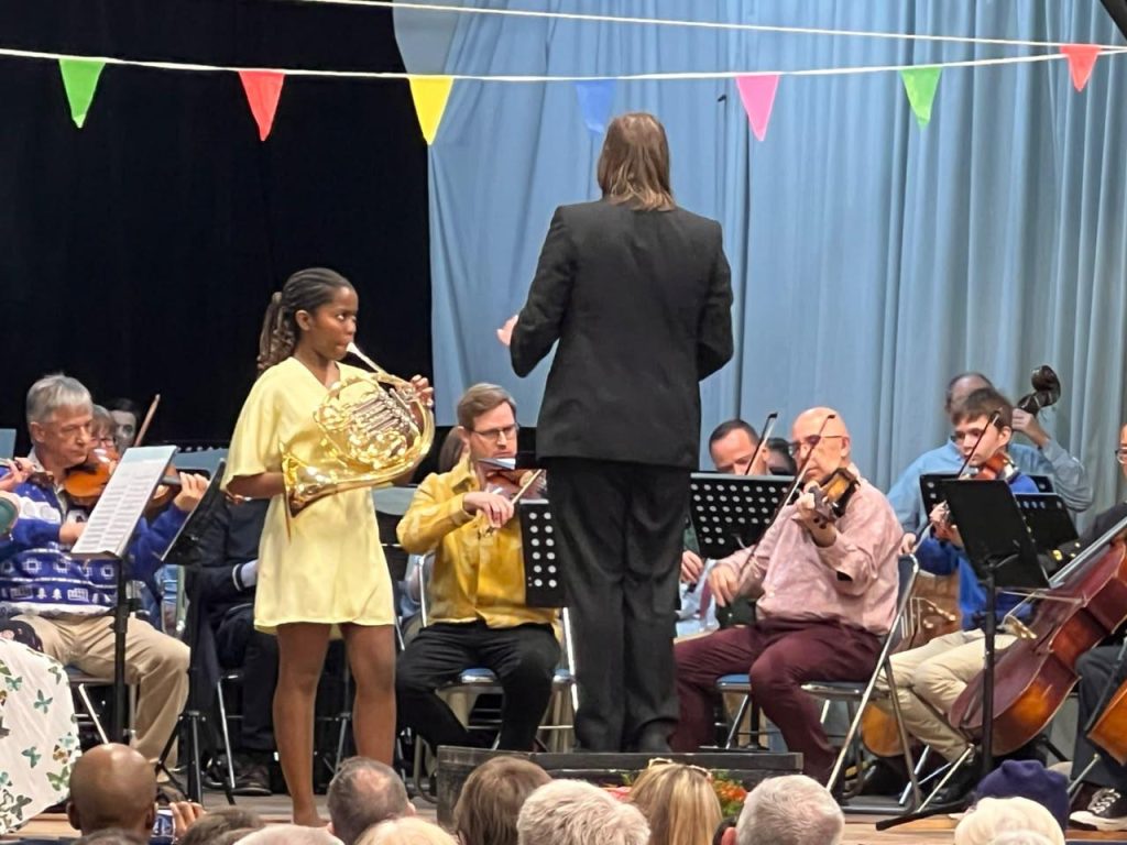 Young girl playing a French horn